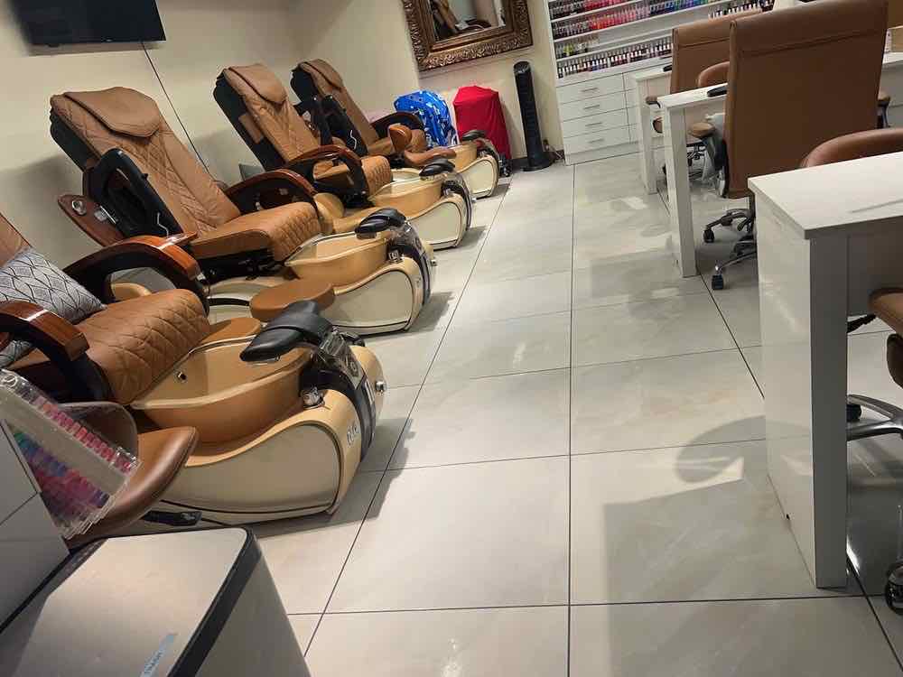 A nail salon with clean tile floors and tidy treatment stations after an evening janitorial visit