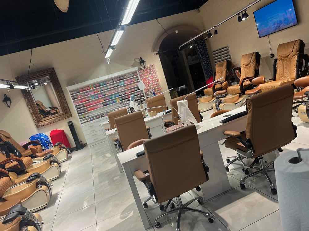 A nail salon interior with clean tiled floors and tidy stations after a janitorial visit